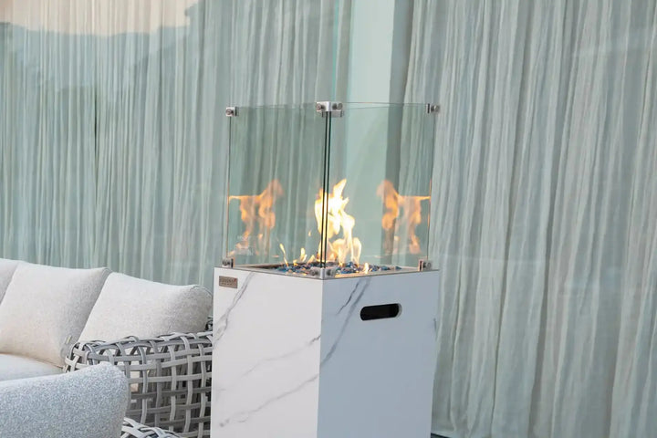 YUKON Marble Porcelain Dining Table - Bianco White B with a modern fire pit and elegant decor.