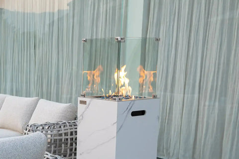 YUKON Marble Porcelain Dining Table - Bianco White B with a modern fire pit and elegant decor.