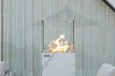 YUKON Marble Porcelain Dining Table - Bianco White B fire pit with glass enclosure and flames, perfect for outdoor settings.
