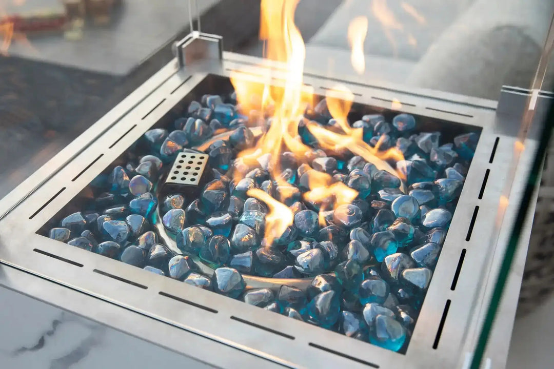 YUKON Marble Porcelain Dining Table - Bianco White B fire pit flames and blue glass pebbles in modern design.