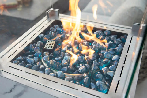 YUKON Marble Porcelain Dining Table - Bianco White B fire pit flames and blue glass pebbles in modern design.